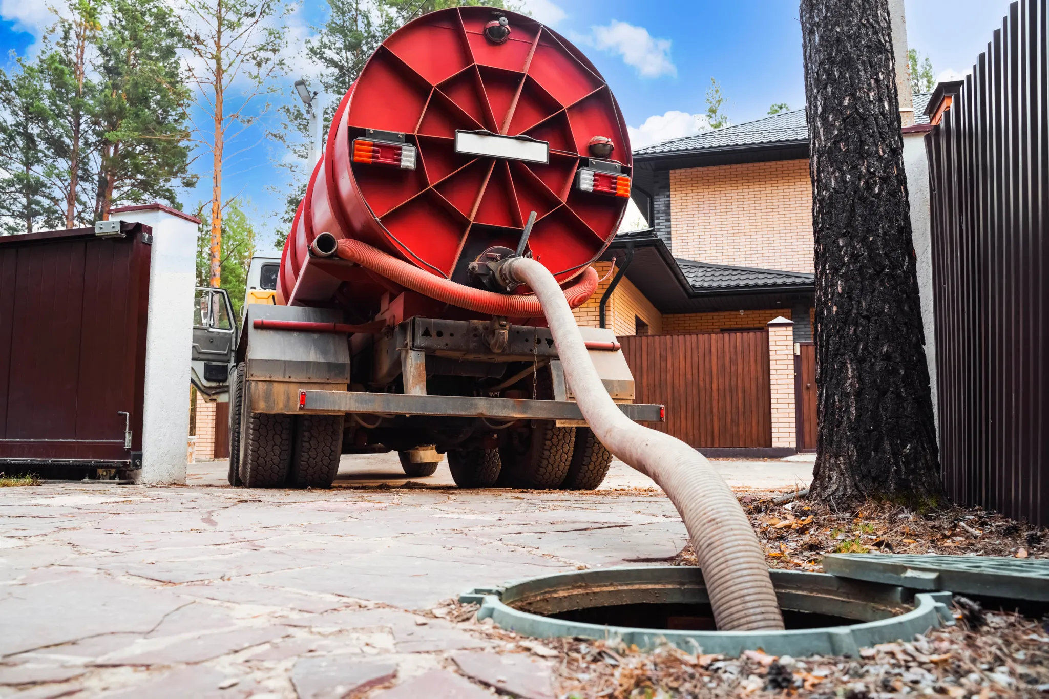 A Durham Region Septic Pumping septic truck servicing a customer's septic tank.